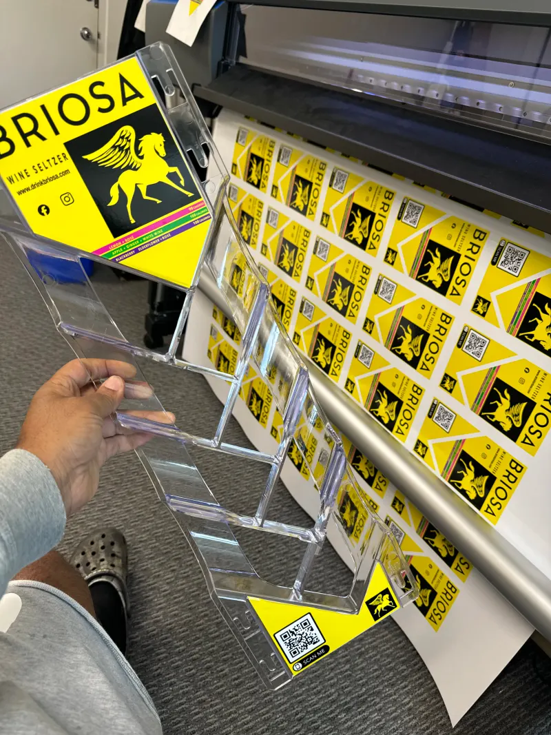 Clear plastic display with stickers applied